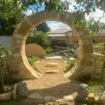 A garden pathway leads to a stone circle, creating a unique and inviting atmosphere.