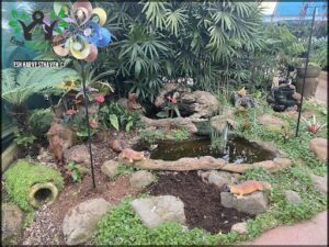 A garden scene with a pond, rocks, and a variety of animals, including a giraffe, a dog, and a bird.