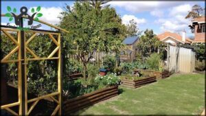 A garden with a variety of plants, including a lemon tree, is situated in front of a house.