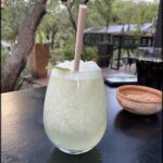 A glass of frozen drink with a straw in it.