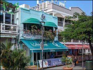 A green awning with the name El Pisador hangs over the entrance of a building.