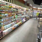A grocery store aisle with a variety of food items.