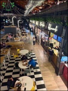 A group of people are sitting at tables in a restaurant.