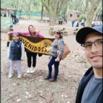 A group of people posing for a picture in front of a sign that says "Bienvenidos".
