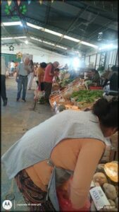 A group of people shopping for vegetables at a market.