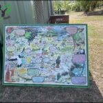 A large, colorful map of the world is displayed on a green background.