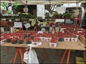 A large display of fresh strawberries for sale.