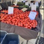 A large display of fresh tomatoes for sale.