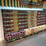 A large display of jams and butters in a store.