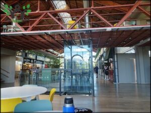 A large glass building with a cafeteria inside.