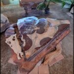 A large rock with a heart shape in it sits on a table.