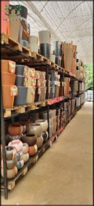 A large selection of pots and vases are displayed in a store.