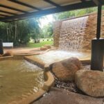 A large waterfall with a pool of water in front of it.