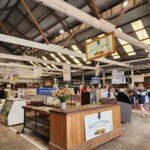 A large wooden building with a sign that says "Fruitful Orchard" on the front.
