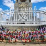 A monument dedicated to the men of the 39th state is adorned with flowers and ribbons.
