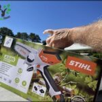 A person is holding a box of a Stihl chainsaw.