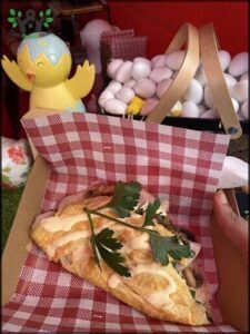 A person is holding a plate with a sandwich on it.
