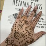 A person's hand with henna tattoos on it.