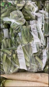 A pile of green vegetables in a plastic bag.