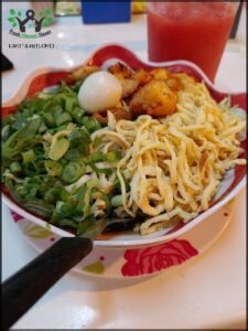 A plate of food with a drink in a cup.