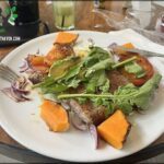A plate of food with a fork and knife on the side.