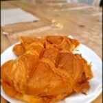 A plate of food with a napkin underneath.