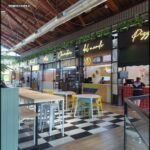 A restaurant with a checkered floor and a pizza shop.
