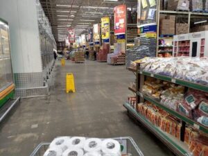 A shopping cart is filled with groceries in a grocery store.