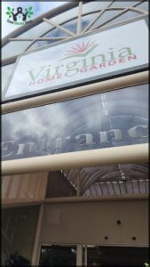 A sign for a garden store hangs from the ceiling.