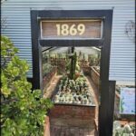 A sign for a nursery with a number 1869 on it.