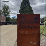 A sign for the Agrarian Kitchen is made of metal.