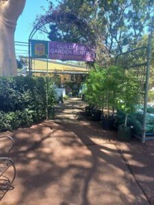A sign for the Guildford Garden Centre is visible in the foreground.