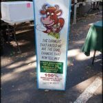 A sign that says "The farmers that raised me are the same farmers that now sell me. This is organically grown!"