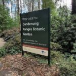 A sign welcoming visitors to the Dandenong Ranges Botanic Garden.