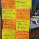 A sign with a list of prices for various items.