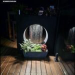 A small waterfall in a planter box on a wooden deck.