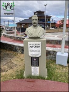 A statue of a man is located in a park.
