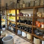 A store with a large variety of pottery and ceramics on display.