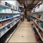 A store with a large variety of pottery on display.