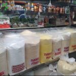 A store with a variety of food items, including rice, spices, and other ingredients.