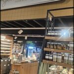 A store with a variety of items for sale, including a large selection of jars and bottles.