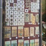 A table filled with various coins and bills, including a 50 cent piece.
