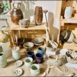 A table full of various vases and bowls.