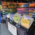 A table with a variety of pictures on it, including a picture of a waterfall.