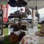 A tent full of hats is set up for a sale.