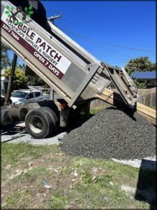 A truck is loaded with gravel, ready to be transported to a construction site.