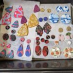 A variety of colorful beads are laid out on a tray, ready to be used in a project.