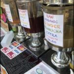 A variety of drinks are available at this stand, including a ginger drink.