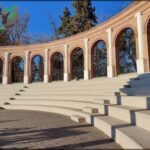 A view of a large circular structure with a set of stairs leading up to it.
