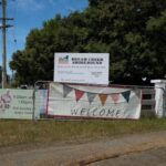 A welcome sign is displayed in front of a fence, inviting visitors to the Dream Catcher Showground.